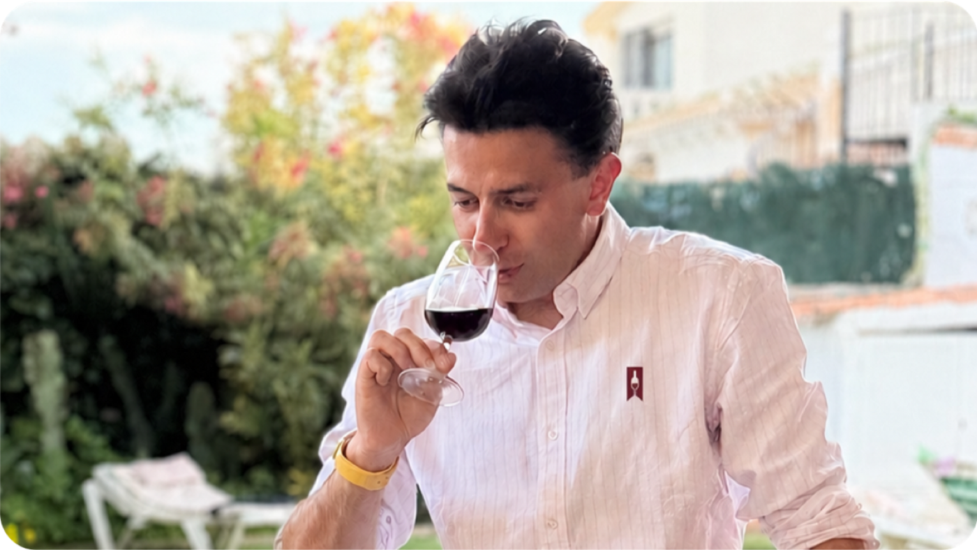 Luke McCorry tasting wine outdoors